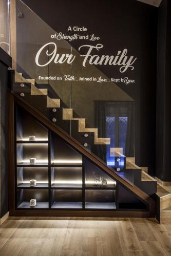 a staircase with a sign that reads our family at Bella Roe Premium Apartments in Belgrade