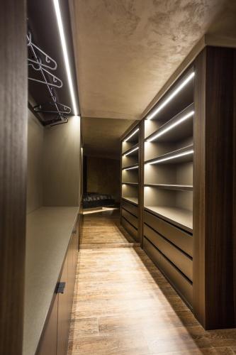 a walk in closet with wooden cabinets and a long hallway at Bella Roe Premium Apartments in Belgrade