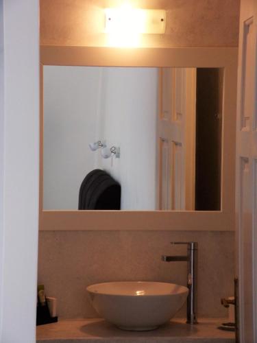 a bathroom with a sink and a mirror at Villa Irini in Naousa