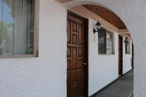 an entrance to a house with a wooden door at State Inn in Chihuahua