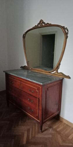 a dresser with a mirror on top of it at Villa Giove Rooms in Prato