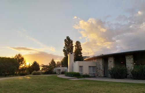 a building with the sunset in the background at Hotel Boutique Posada Piedras Blancas in Santa Rosa