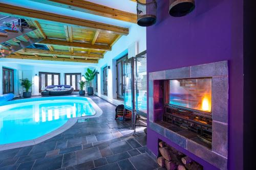 an indoor swimming pool with a fireplace in a house at “Moment s“ pool house Trakoscan in Trakošćan