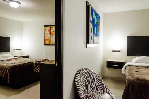 Un pat sau paturi într-o cameră la Hotel Velario