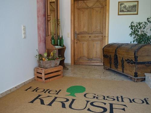 a room with a door and a floor with a rug at Hotel Gasthof Kruse in Nottuln