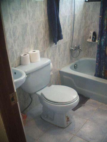 a bathroom with a toilet and a sink and a tub at Dre Broeders Apartments Juan Dolio in Juan Dolio