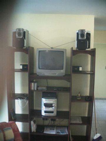 a living room with a tv and two speakers at Dre Broeders Apartments Juan Dolio in Juan Dolio