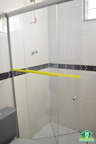 a shower with a glass door in a bathroom at Hotel e Restaurante Residencial in Montes Claros