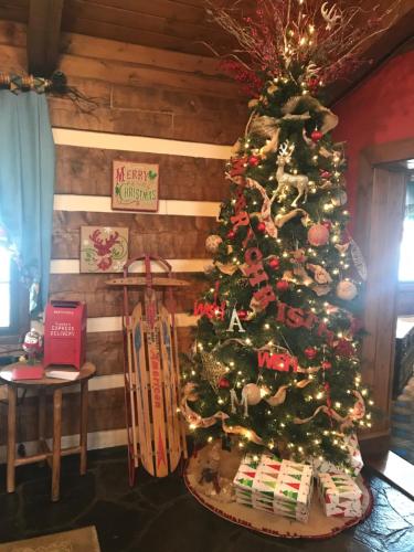 a christmas tree in the corner of a room at Great Smokies Inn - Cherokee in Cherokee