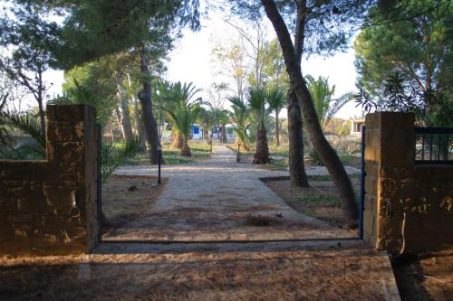 an entrance to a park with a gate and trees at The SURF hOuSe @ Keros Beach , Kalliopi in Kalliópi
