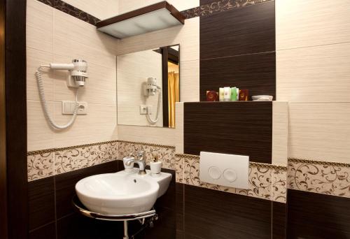 a bathroom with a sink and a mirror at Belle Royalle in Lisarnya