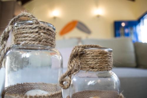 a glass vase with a rope on a table at The SURF hOuSe @ Keros Beach , Kalliopi in Kalliópi
