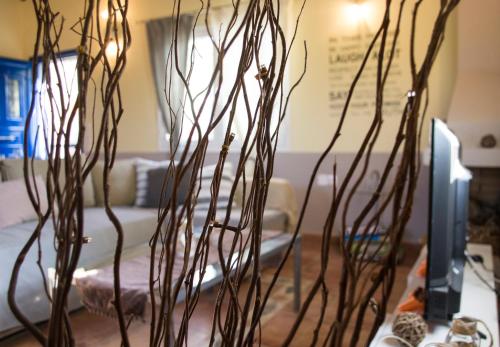a vase filled with branches on a table at The SURF hOuSe @ Keros Beach , Kalliopi in Kalliópi