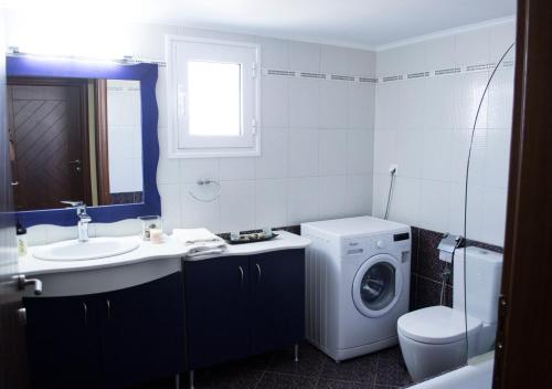 a bathroom with a washing machine and a sink at The SURF hOuSe @ Keros Beach , Kalliopi in Kalliópi