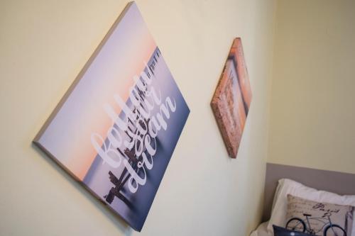 a sign on a wall with two pictures on it at The SURF hOuSe @ Keros Beach , Kalliopi in Kalliópi