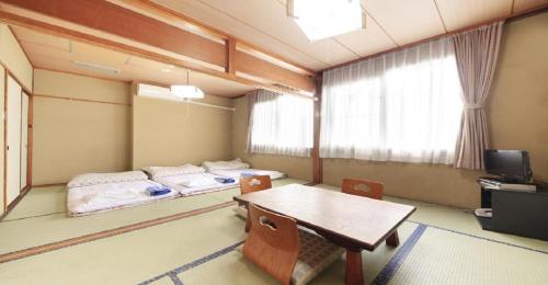 a room with two beds and a table and chairs at Yu-topia / Vacation STAY 8765 in Kai