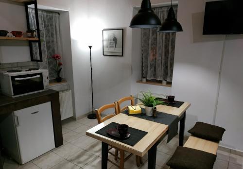 a living room with a table and a kitchen at kalimera in Preveza