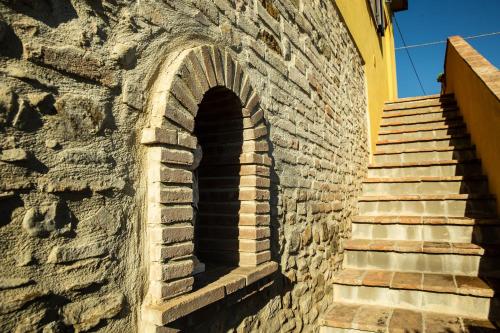 a brick wall with a staircase next to a building at Appartamento Della Pia in Bevagna