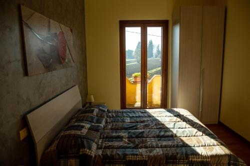 a bedroom with a large bed and a window at Appartamento Della Pia in Bevagna