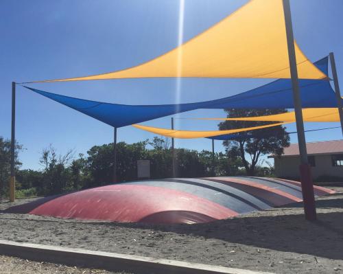 a yellow and blue umbrella on top of a skate park at Greymouth Seaside TOP 10 Holiday Park in Greymouth