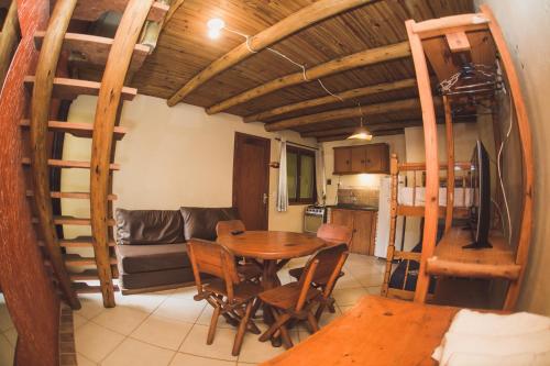 a kitchen and dining room with a table and chairs at Pousada Pé na Areia in Garopaba