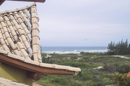 a view of the ocean from a roof of a house at Pousada Pé na Areia in Garopaba