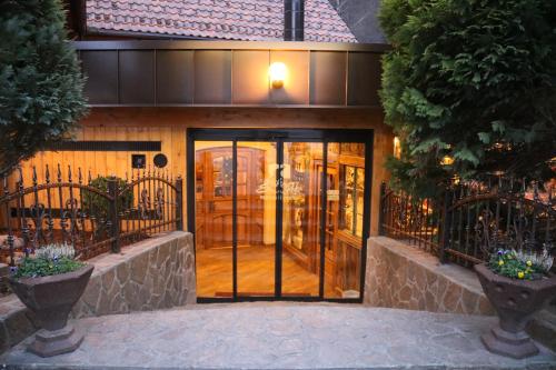 a house with a revolving door in front of it at Gorska Reka Guesthouse in Zreče
