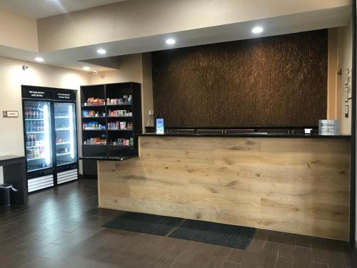a restaurant with a counter and a drink cooler at Comfort Inn & Suites O'Fallon - St Louis Area in O'Fallon