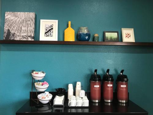 a shelf with bottles and bowls on a table at Comfort Inn & Suites O'Fallon - St Louis Area in O'Fallon