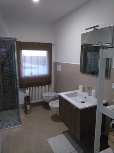 a bathroom with a toilet and a sink and a shower at La Casetta in Vittorio Veneto