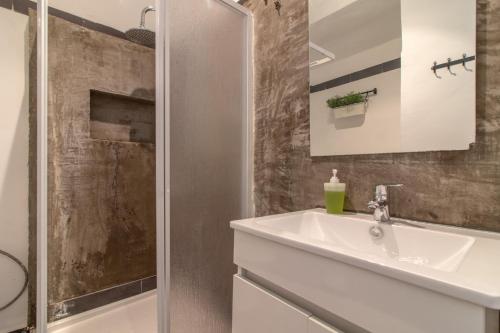 a bathroom with a white sink and a shower at Party Zone in Lisbon