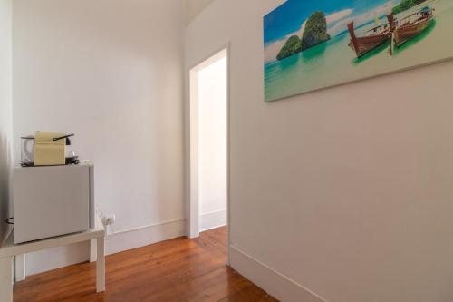 a room with a painting on the wall and a table at Party Zone in Lisbon