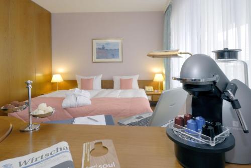 a robot sitting on a desk in a hotel room at Radisson Blu Hotel Cottbus in Cottbus