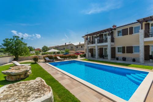 a swimming pool in the yard of a house at Bed & Breakfast Daniela in Veleniki