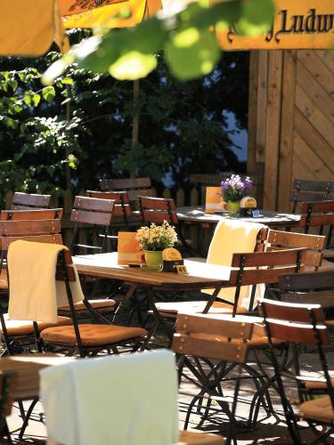 a group of tables and chairs with flowers on them at Gasthof Rössle in Rieden am Forggensee