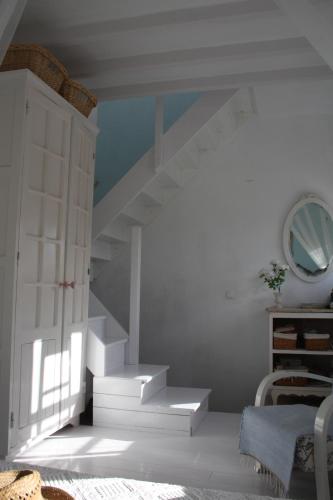 a white staircase in a room with a mirror at Silves Historical House in Silves