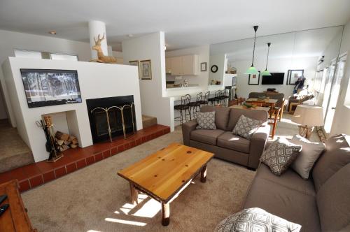 a living room with a couch and a coffee table at Cozy 1 Bedroom East Vail Condo #2C. Shuttle, Hot Tub, and Market on Site. in Vail