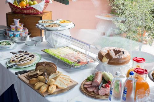 a table topped with lots of different types of food at Country Hotel & Resort I Calanchi in Ripatransone