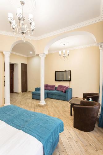 a hotel room with a bed and a couch at Hotel Baron in Odesa