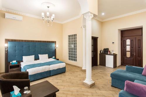 a hotel room with a bed and a couch at Hotel Baron in Odesa