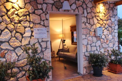 a room with a stone wall and a doorway at Ifestos Villa in Fira