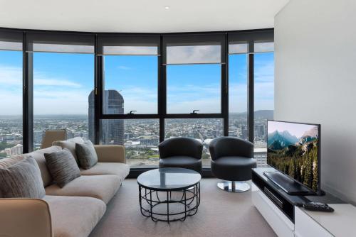 a living room filled with furniture and a tv at Brisbane Skytower in Brisbane