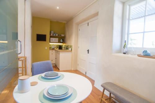 a white table with plates on it in a kitchen at Woodstock Suite in Nelson