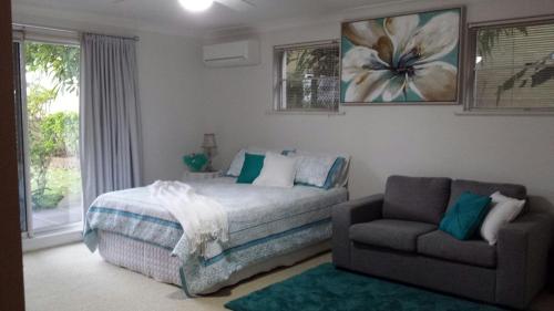 a bedroom with a bed and a couch and a chair at Bella Vista B @ B in North Haven