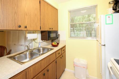 a kitchen with a sink and a refrigerator at Bamboo Apartments in Holmes Beach