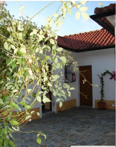 a building with a door and a plant at Harry's Studios 1 in Gaios