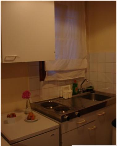 a small kitchen with a sink and a counter top at Harry's Studios 1 in Gaios