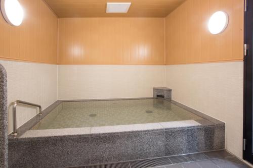 a large bath tub in a room with at Kuretake-Inn Hamamatsueki Minamiguchi Premium in Hamamatsu