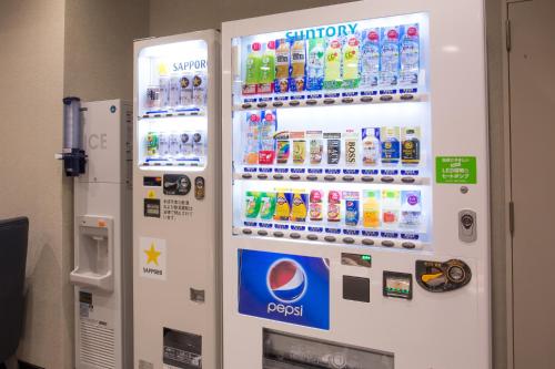 a vending machine filled with bottles of soda at Kuretake-Inn Hamamatsueki Minamiguchi Premium in Hamamatsu