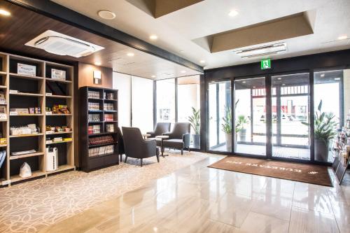 a lobby of a store with chairs and books at Kuretake-Inn Hamamatsueki Minamiguchi Premium in Hamamatsu